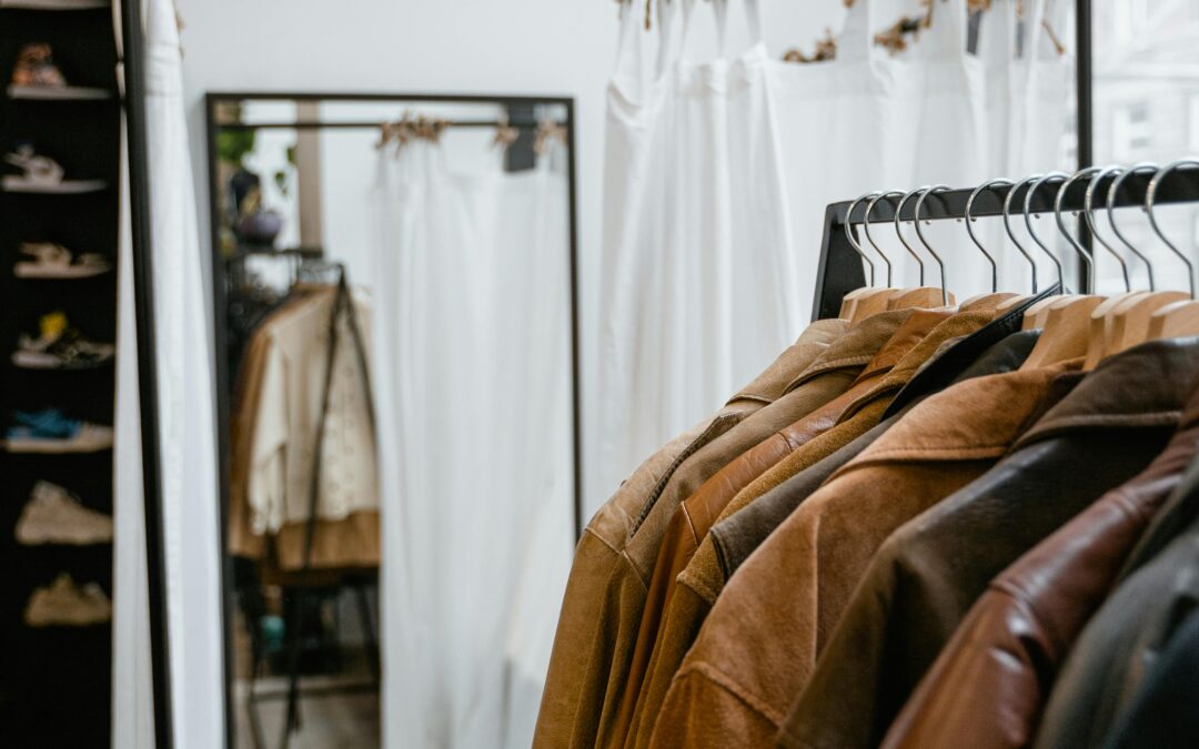 Vegetable-tanned luxury leather jackets in tan and brown tones hanging on a rack in a boutique store in India
