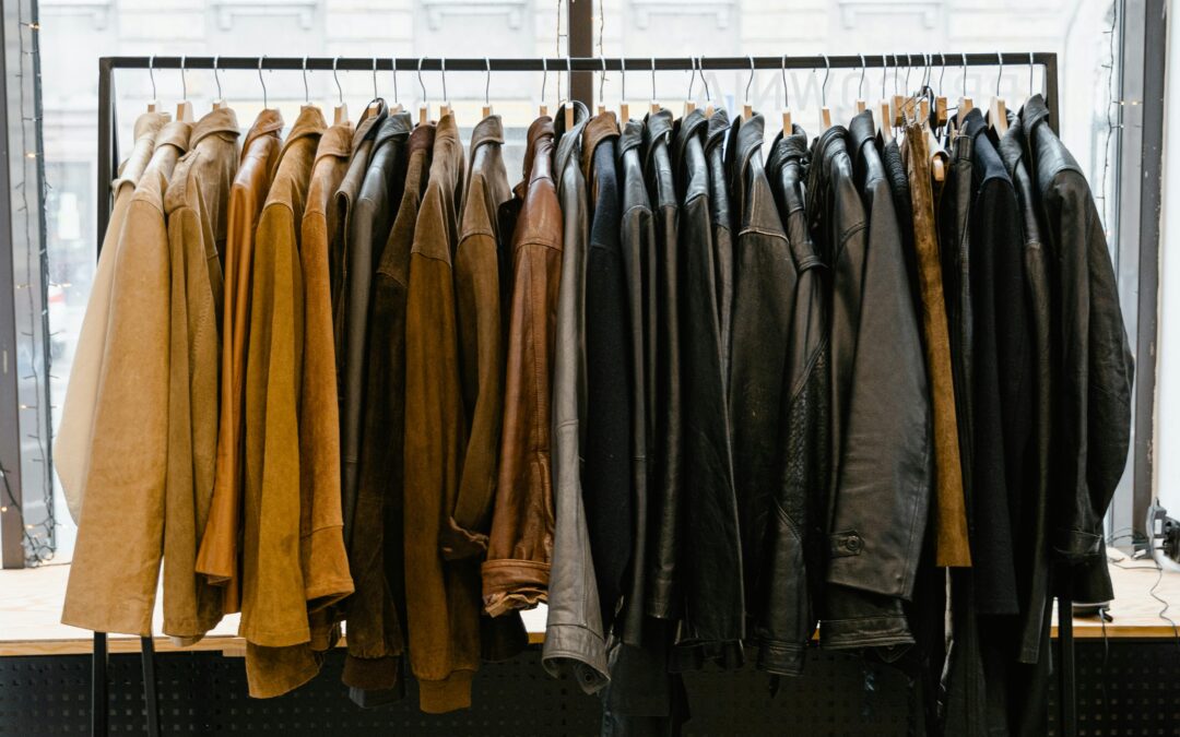 Full rack of luxury leather jackets in tan, brown, and black showing range of styles available in India